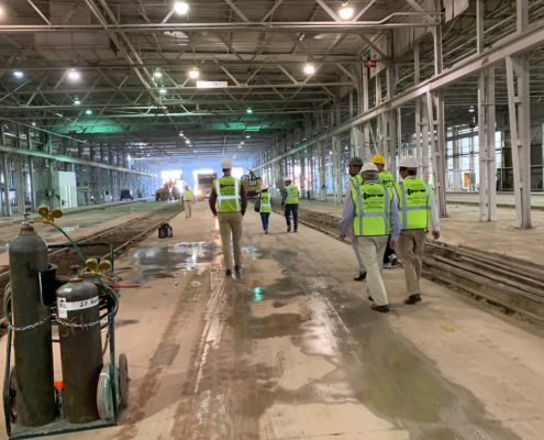 Back view of Connor Construction experts walking through construction site