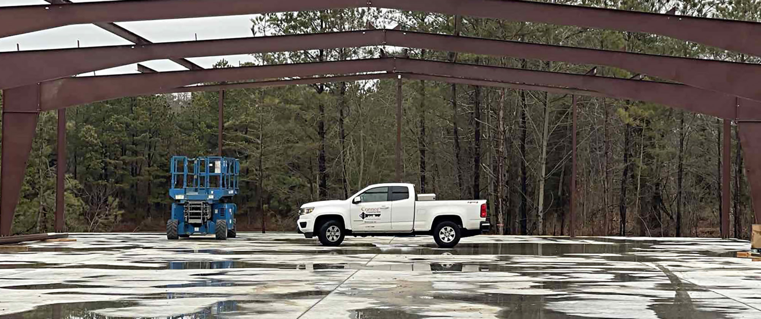 Side view of Connor Construction truck at work site