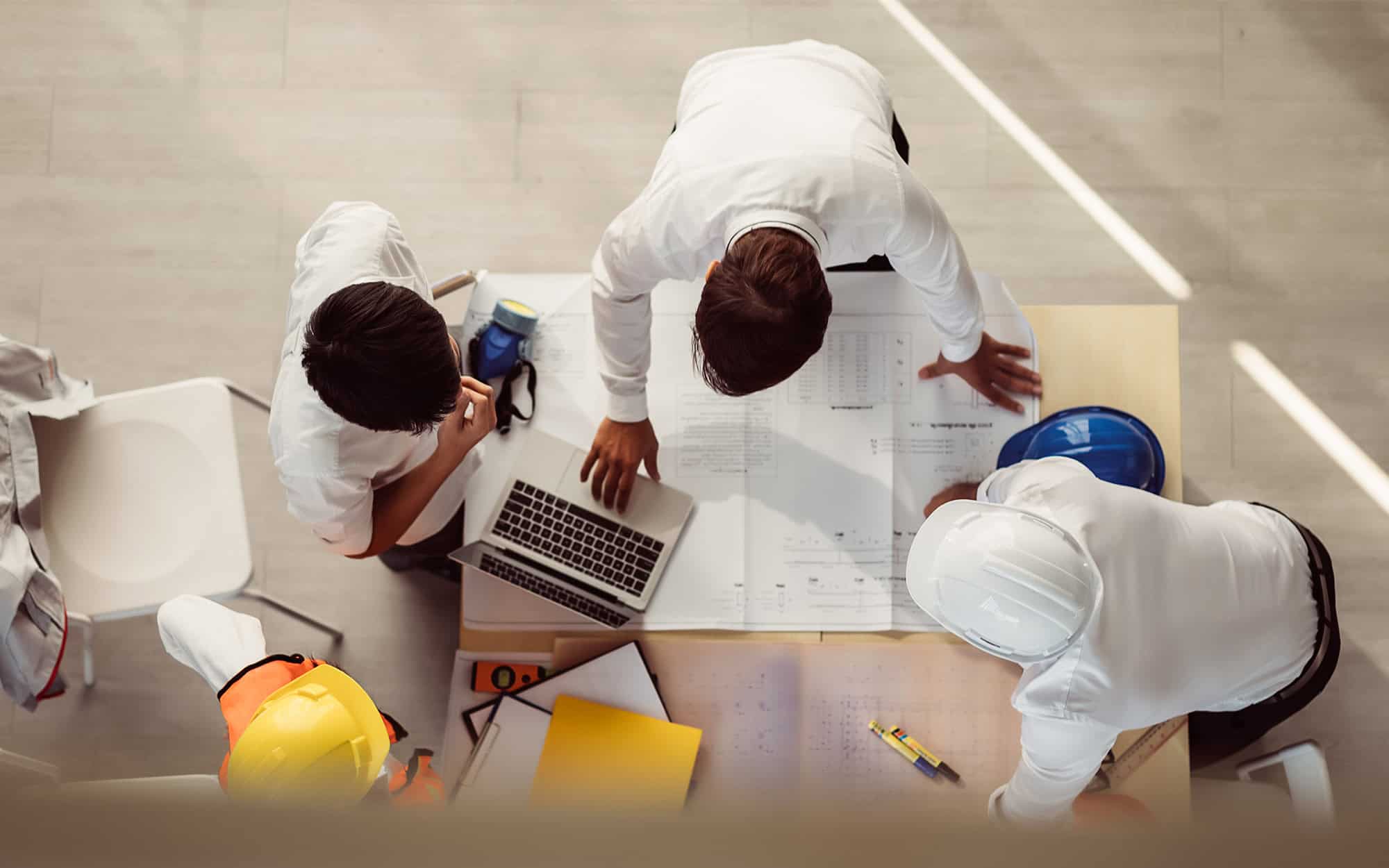 Top-down view of contractors in project meeting