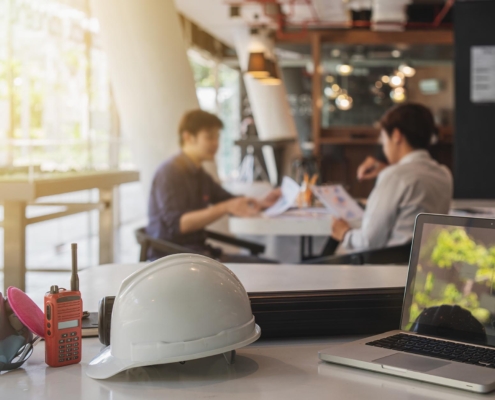 two workers discussing remodeling plans of restaurant